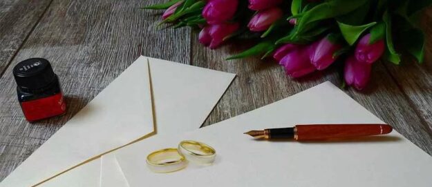Rings on envelopes with pen and bouquet of flowers | Grounds for divorce in Kenya | Njaga & Co. Advocates family law firm in Kenya