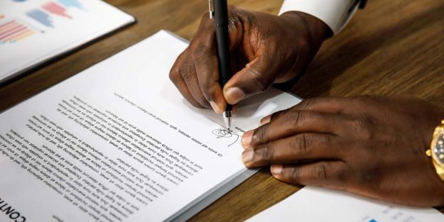 contract-termination-blog A gentleman signing employment documents | The Process of Terminating Employment Contracts During Probationary Periods in Kenya | Njaga Advocates employment lawyer