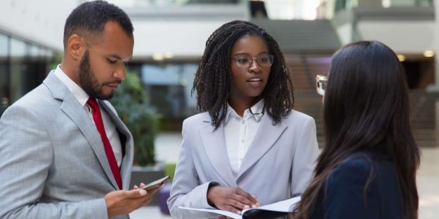 BRS Njaga (2) A group of three people professionally dressed discussing outdoors while standing | Beneficial Ownership in Kenya | Njaga Advocates Corporate & Commercial legal articles