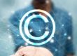 A person's hand interacting with a digital copyright symbol | Protecting Ideas in Kenya Using Intellectual Property | Njaga & Co. Advocates Intellectual property law firm