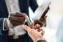 An African descent man handing over keys to a Caucasian man while holding documents in hand | The Best Forum for Instituting a Claim for Refund of Security Deposit from Your Landlord | General litigation lawyers in Nairobi | Njaga Advocates dispute resolution lawyers