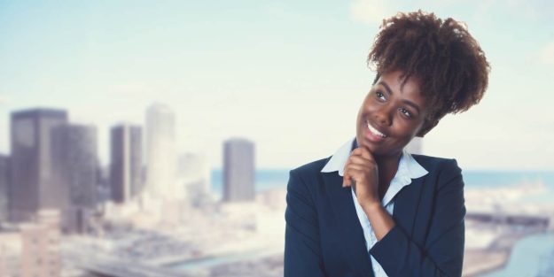 business idea in kenya African descent lady smiling while holding her chin looking up with a city background | A Guide for Foreign Investors Starting a Business in Kenya | Foreign investment in Kenya | Njaga & Co Advocates Corporate Commercial lawyers | Immigration law advisory in Nairobi